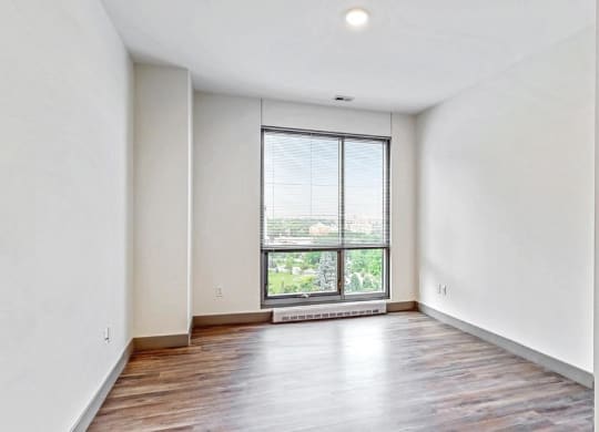 Spacious bedroom with floor-to-ceiling windows a 2 bedroom penthouse floor plan Midtown Crossing Apartments Omaha