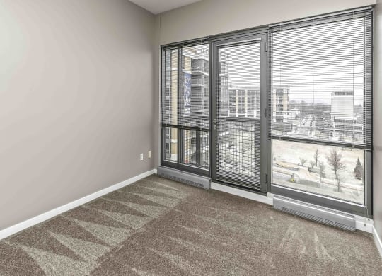 Bright Carpeted Living Room at Midtown Crossing Apartments, Omaha, NE, 68131
