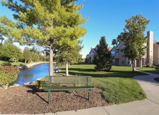 Exteriors-Sitting bench next to private pond at Stone Ridge Estates townhomes in Lincoln, NE