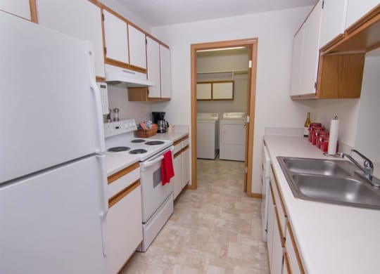 Galley style kitchen with attached laundry at The Northbrook Apartments in Lincoln NE