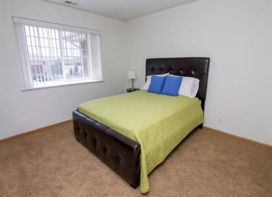 Bedroom with large window in The Northbrook Apartments in Lincoln NE