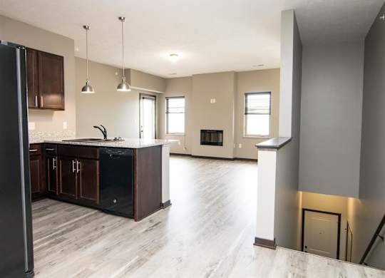 Kitchen and living room with view of stairs to the lower level at North Pointe Villas