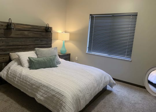 Furnished bed room with full size bed at north pointe villas in lincoln nebraska