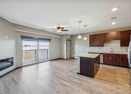 A spacious living room with a fireplace and sliding glass doors.