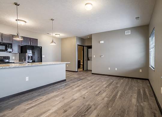 Large open concept floor plan with hardwood-style flooring at North Pointe Villas