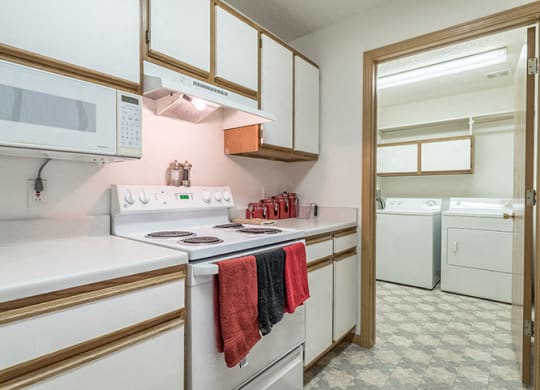 Kitchen with lots of storage and attached laundry room at The Northbrook Apartment Homes, Lincoln, NE