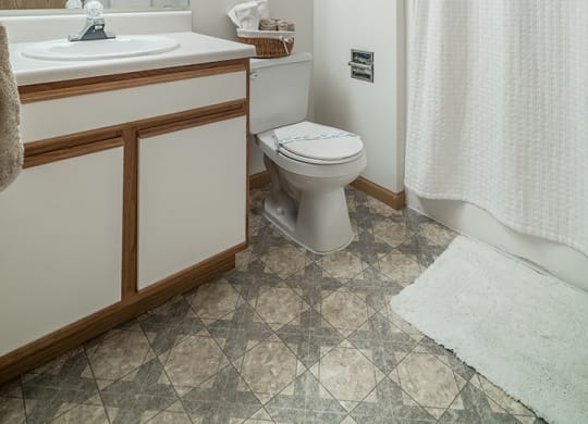 Bathroom with bright lighting and vanity at The Northbrook Apartment Homes, Lincoln, NE