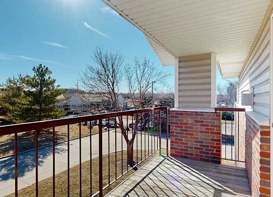 balcony view overlooking trees and yard
