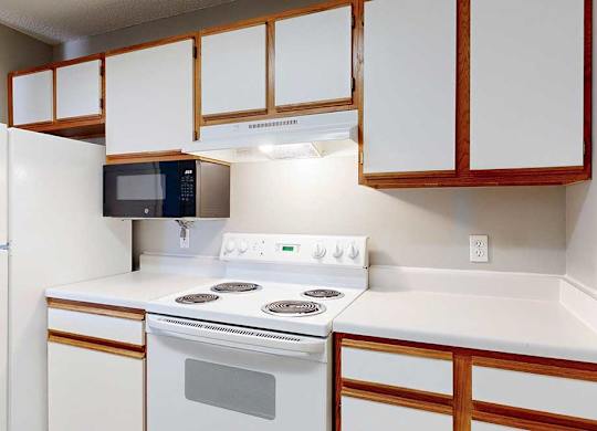 kitchen with white stove with a microwave and refridgerator