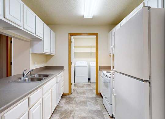 A kitchen with white appliances and cabinets.