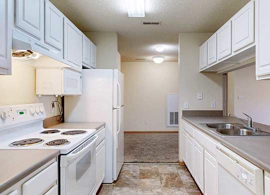 a kitchen with white appliances and cabinets