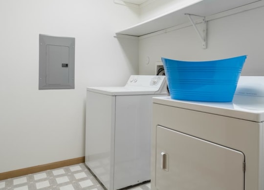 a laundry room with two washes and a dryer