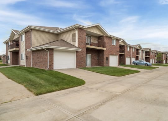 Exterior of Northbrook Apartments with attached garages and lawns
