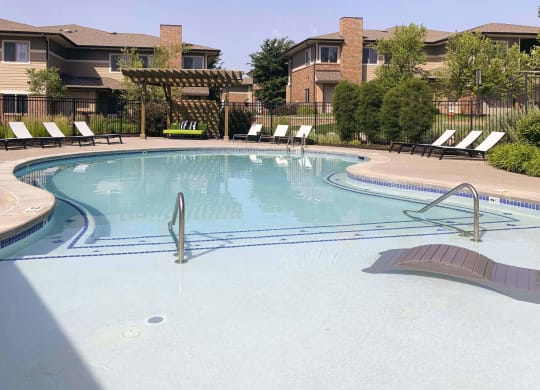 Resort style swimming pool with sun tanning loungers at North Pointe  Villas Lincoln Nebraska