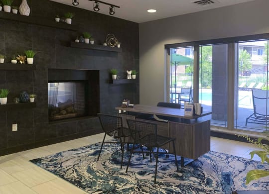front desk with two chairs and a large window in the clubhouse at north pointe villas in lincoln
