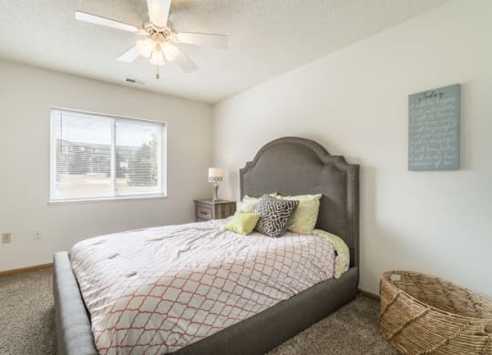 Bedroom with ceiling fan and natural light at Northridge Heights in north Lincoln