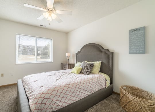 Bedroom with ceiling fan and natural light at Northridge Heights in north Lincoln