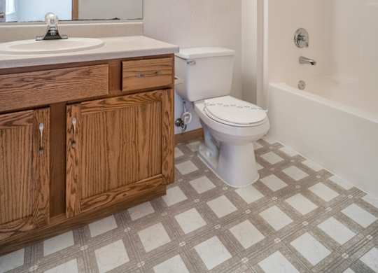an empty bathroom with a toilet and a sink