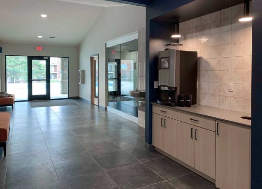 a lobby with a coffee maker and two drinking fountains