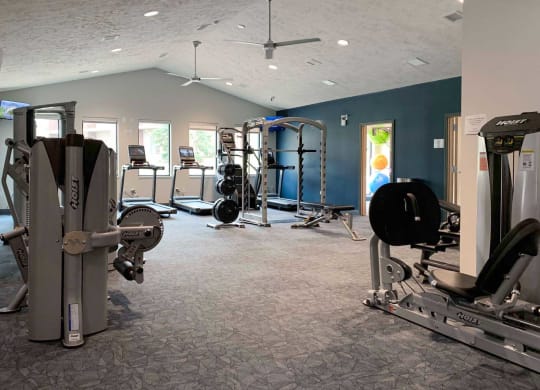 a gym with weights and other exercise equipment in a room