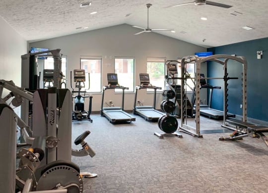 a gym with various weights and cardio equipment in a large room