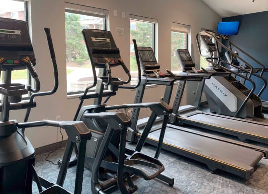 a group of exercise machines in a gym