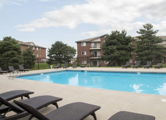 Swimming pool with lounge chairs at Northridge Heights apartments in North Lincoln