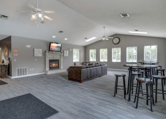 Clubhouse with seating areas, TV, and fireplace at Northridge Heights Apartments