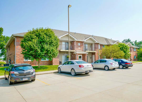 Parking lot with cars and multi-story apartment buildings
