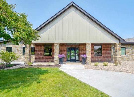 Clubhouse building entrance with landscaped surroundings