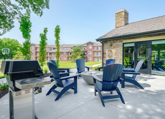Firepit seating area with cozy chairs and apartment buildings nearby