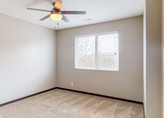 Large renovated bedroom with ceiling fan at Northridge Heights apartments in Lincoln