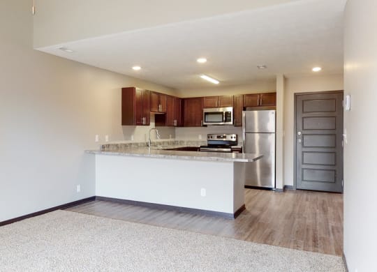 Open dining and living area with carpeted floors at Northridge heights in lincoln nebraska