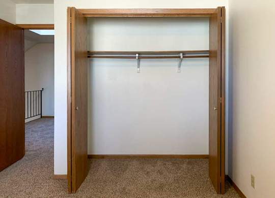 a closet with built-in shelf and hanging space
