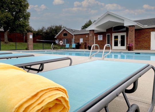 Resort style swimming pool with sun tanning loungers at Ridge Pointe Villas in South Lincoln Nebraska