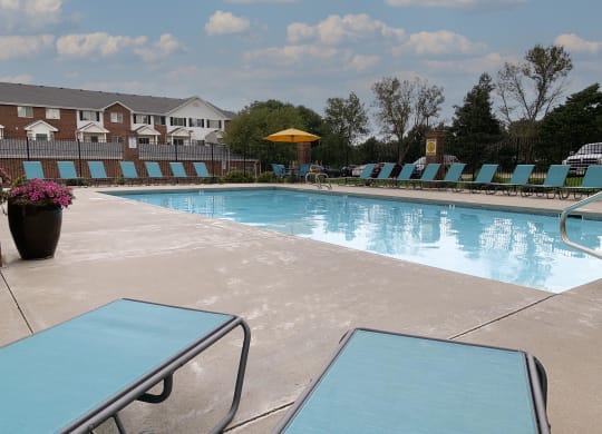 Resort style swimming pool with sun tanning loungers at Ridge Pointe Villas in South Lincoln Nebraska
