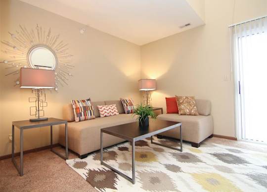 a living room with lots of natural lighting at Pine Lake Heights Apartments in Lincoln Nebraska