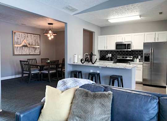 clubhouse lounge space and kitchen with a couch and a table