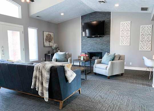 a clubhouse community room with a couch and a tv