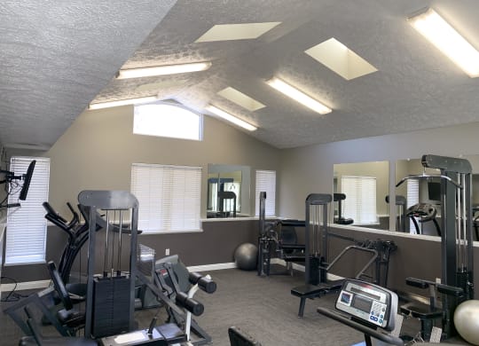 24 hour fitness center with strength training equipment and machines at Pine Lake Heights Apartments in Lincoln Nebraska