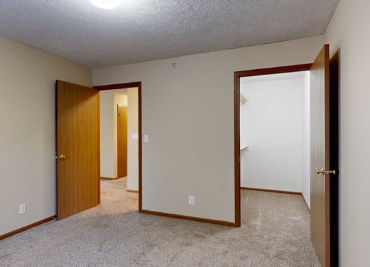 a bedroom with an attached large walk-in closet