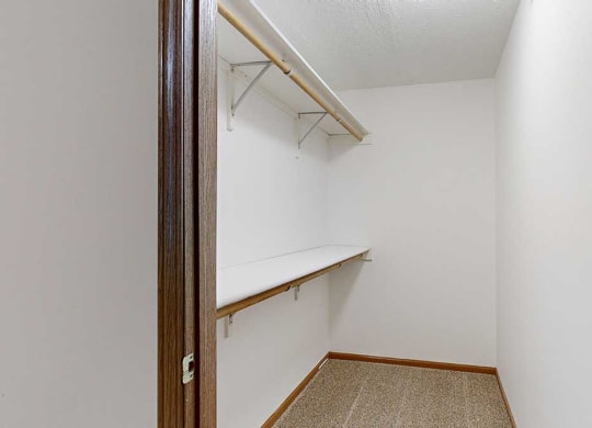 a walk-in closet with built-in shelves and hanging space for ample storage