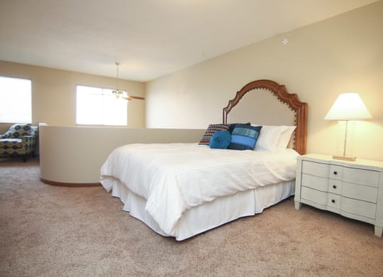 Lofted bedroom with two windows and area over looking living room below