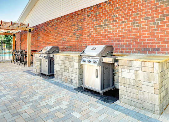 Two outdoor grilling stations with stone counters, perfect for grilling up your favorite recipes.