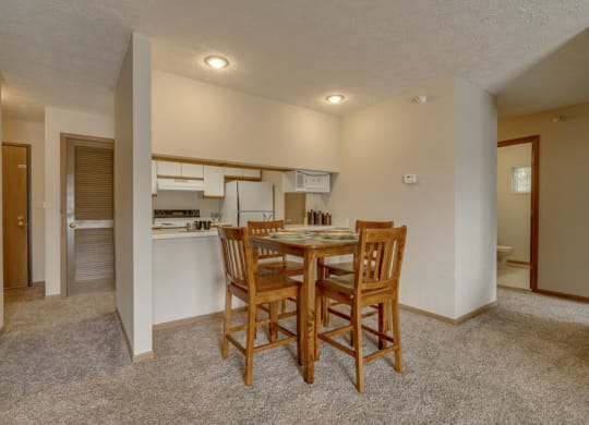 Dining area and kitchen view at Pine Lake Heights Apartments