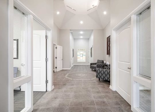 an open lobby space with an office space off to each side
