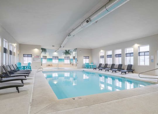 an indoor swimming pool with rows of chairs