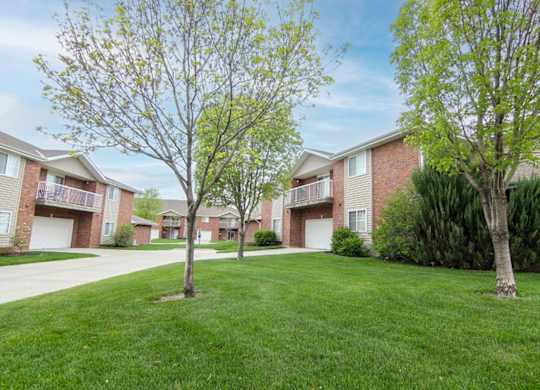 A grassy area in front of apartment buildings.