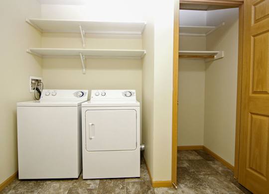 A small laundry room with a washer and dryer.