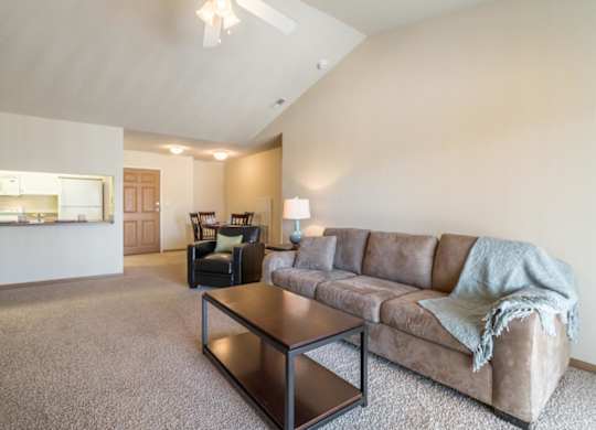 A living room with a couch, chair, and coffee table.